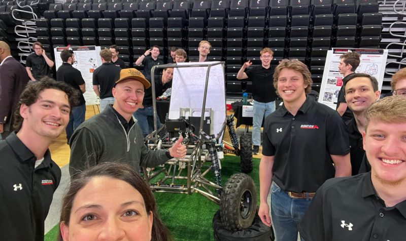 Bearcats Racing Club members pose with Suzie Engle from Motz Engineering around a custom off-road vehicle